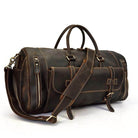 Hot leather carry-on bag with sturdy handles and adjustable shoulder strap for travel convenience