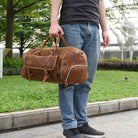 Man holding a stylish hot leather carry-on bag perfect for travel and weekend getaways
