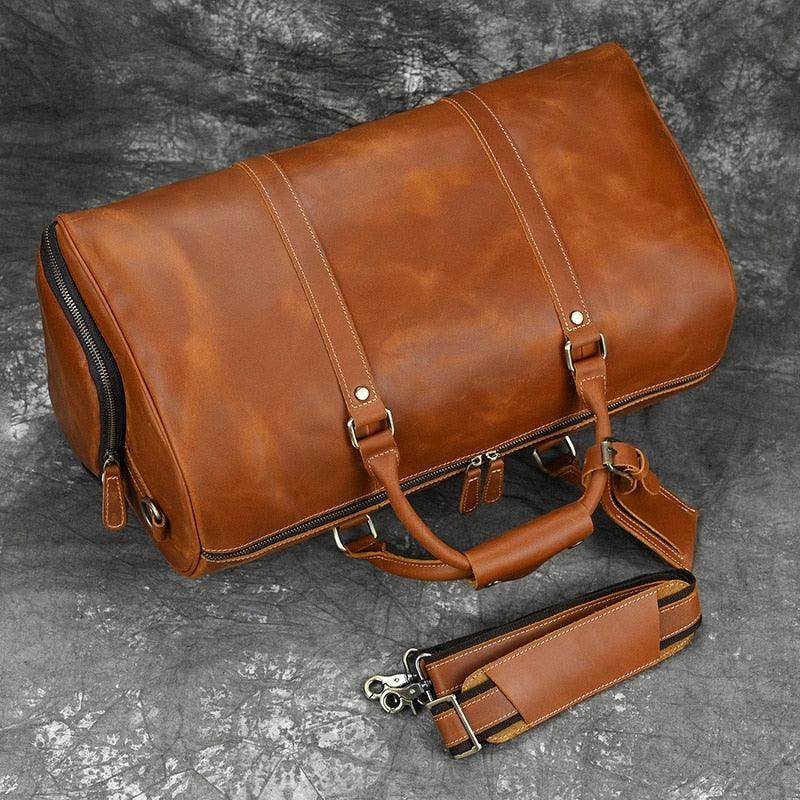 Hot leather carry-on bag in rich brown color with sturdy handles and adjustable shoulder strap
