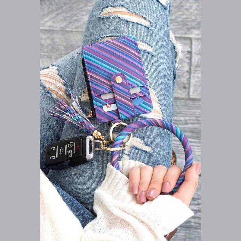 Colorful Aili's Corner ID holder keychain bracelet with card holder and key fob on denim jeans