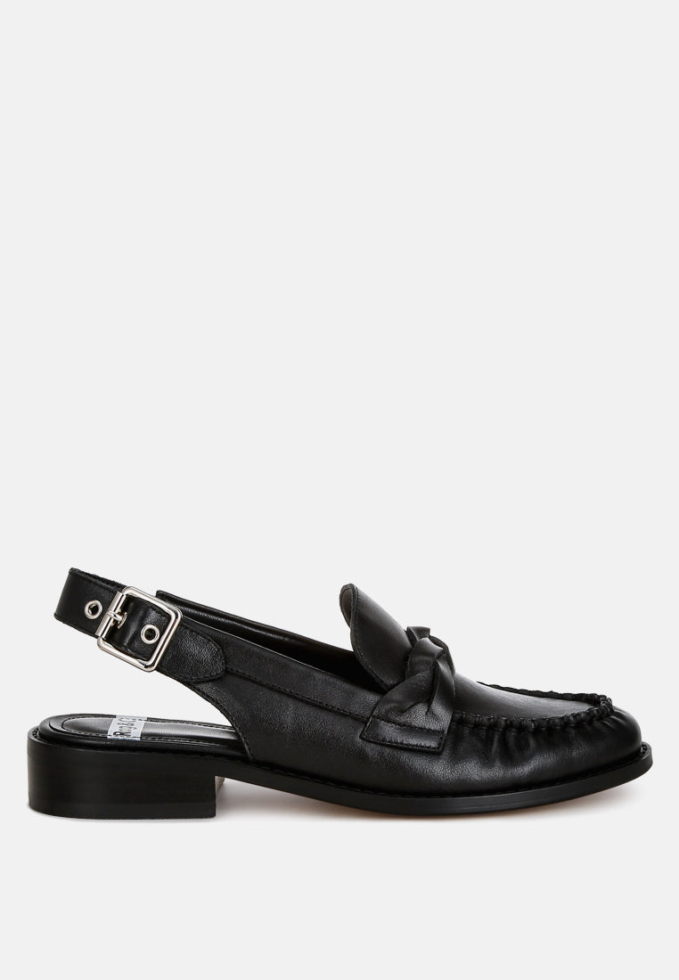 Black loafer with a strap on a white background