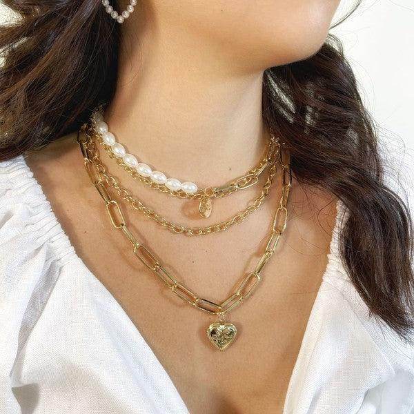 Stylish jester necklace for women showcased with layered gold and pearl chains