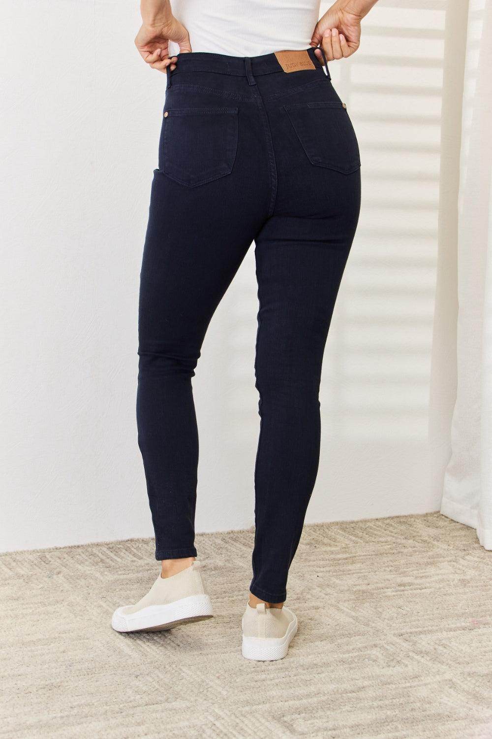 Back view of women's Judy Blue tummy control skinny jeans in dark wash for a flattering fit