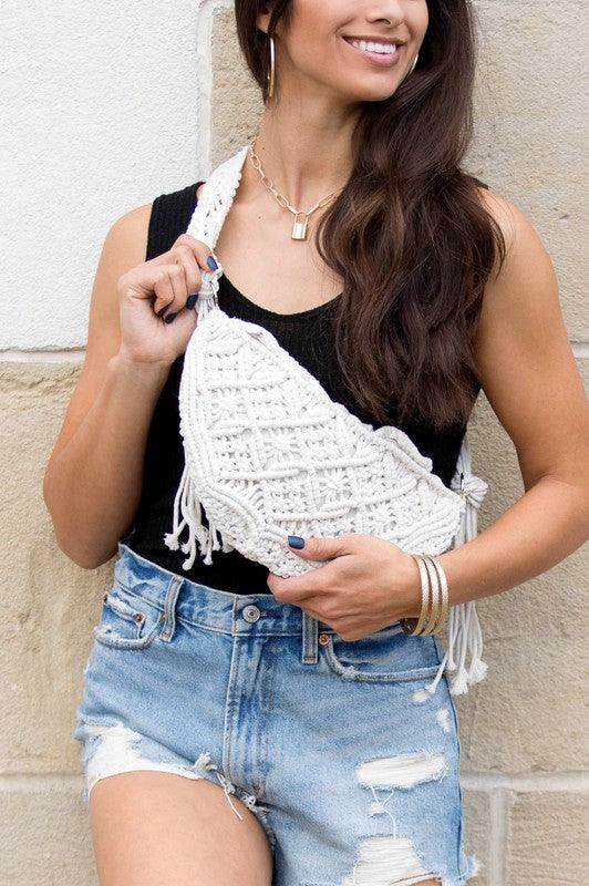 Aili's Corner khaki sling bag vacation styled with casual summer outfit and distressed denim shorts