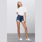 Insane Gene lace lining denim shorts in blue with frayed hem and paired with a white blouse