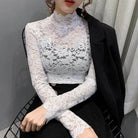 Elegant white lace tops for women featuring long sleeves and a high neckline, perfect for stylish occasions