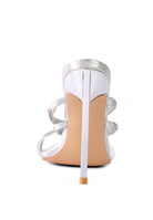 Silver strappy stiletto heeled sandals by Rag Company shown from the back with high thin heels