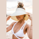Large brim bow beach hat from Aili's Corner, perfect for sunny days by the sea