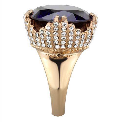 Large gemstone cocktail ring with a purple stone and crystal accents set in a gold-tone band