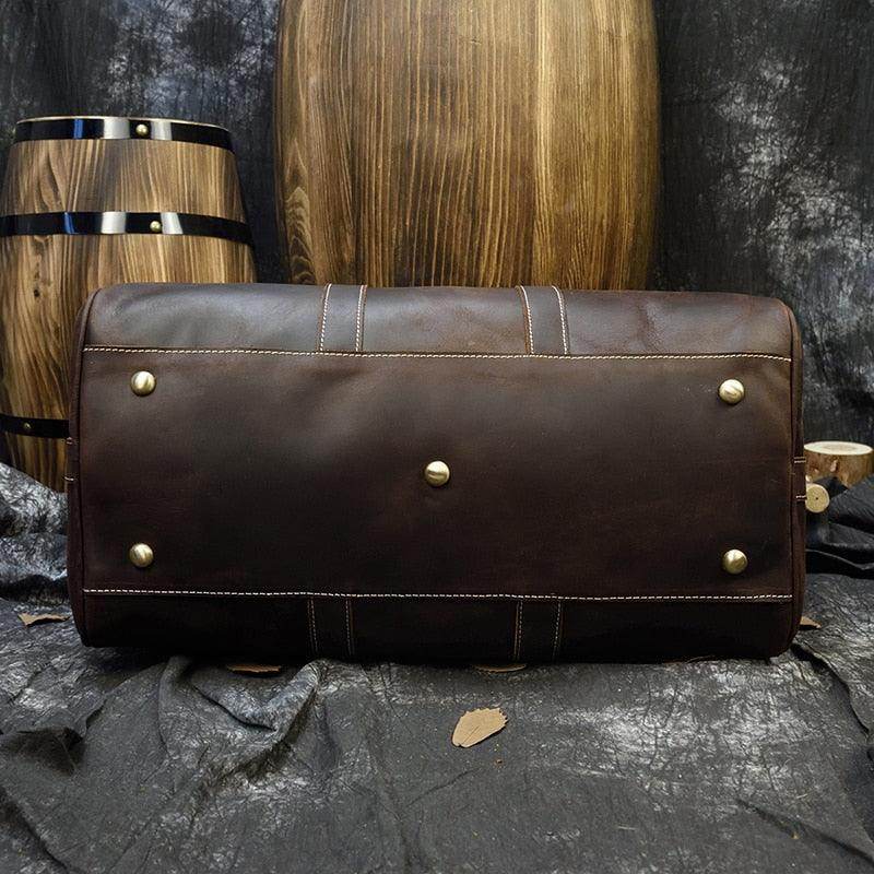 Large leather weekend bag by VacationGrabs with durable bottom studs for stability and style