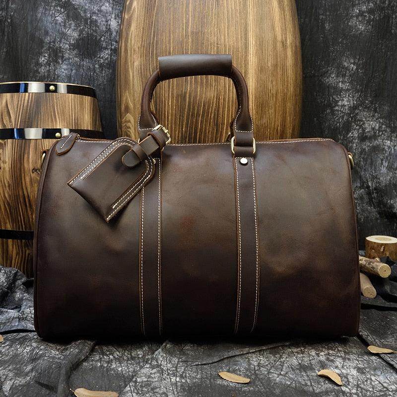 Large leather weekend bag by VacationGrabs in dark brown with sturdy handles and a luggage tag