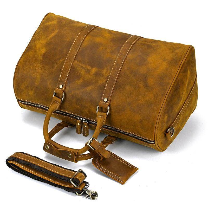 Large leather weekend bag in a rich tan color with sturdy handles and detachable strap