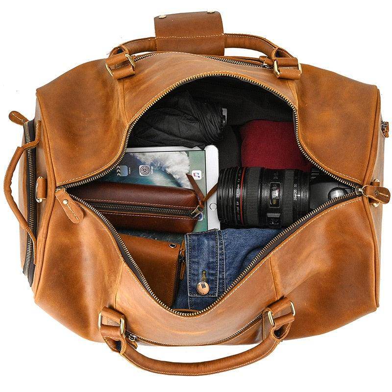Large leather weekend bag in tan color with spacious interior for travel essentials and electronics
