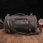 Large travel bag for men in dark brown leather with adjustable shoulder strap and multiple pockets