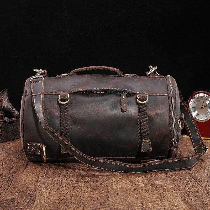 Large travel bag for men in rugged brown leather with durable shoulder strap and multiple pockets