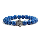Lava stone pet bracelet featuring a blue design and a silver paw print charm for pet lovers