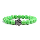 Lava stone pet bracelet with green beads and a stylish paw charm for pet lovers
