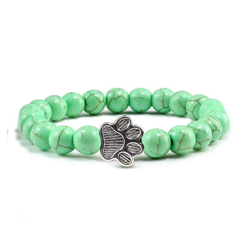 Lava stone pet bracelet with green beads and a silver paw charm, perfect for pet lovers