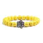 VacationGrabs lava stone pet bracelet with yellow beads and a paw print charm for pet lovers