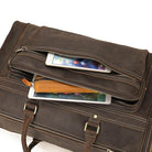 Brown leather luggage tote bag with spacious compartments and zippered pockets for easy access