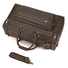 Brown leather luggage tote bag with multiple compartments and a detachable strap for easy carrying