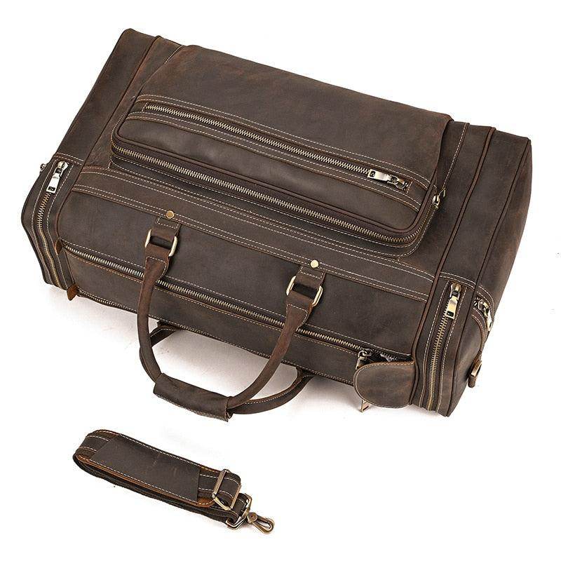 Brown leather luggage tote bag with multiple compartments and a detachable strap for easy carrying