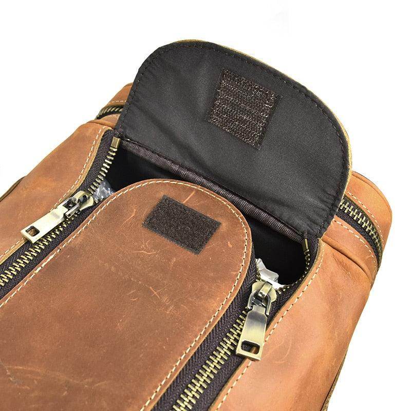 Close-up of leather luggage tote bag showing top zipper and interior pocket for easy access