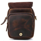 Brown leather messenger bag with a fold-over flap and zippered pockets for practical use