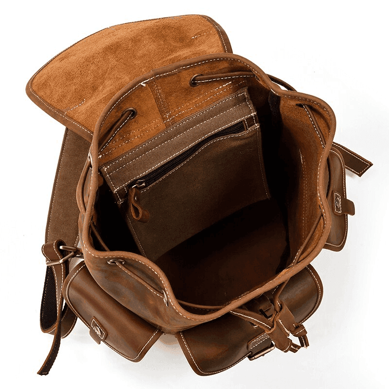 Interior view of a leather travel backpack featuring multiple compartments and a stylish design