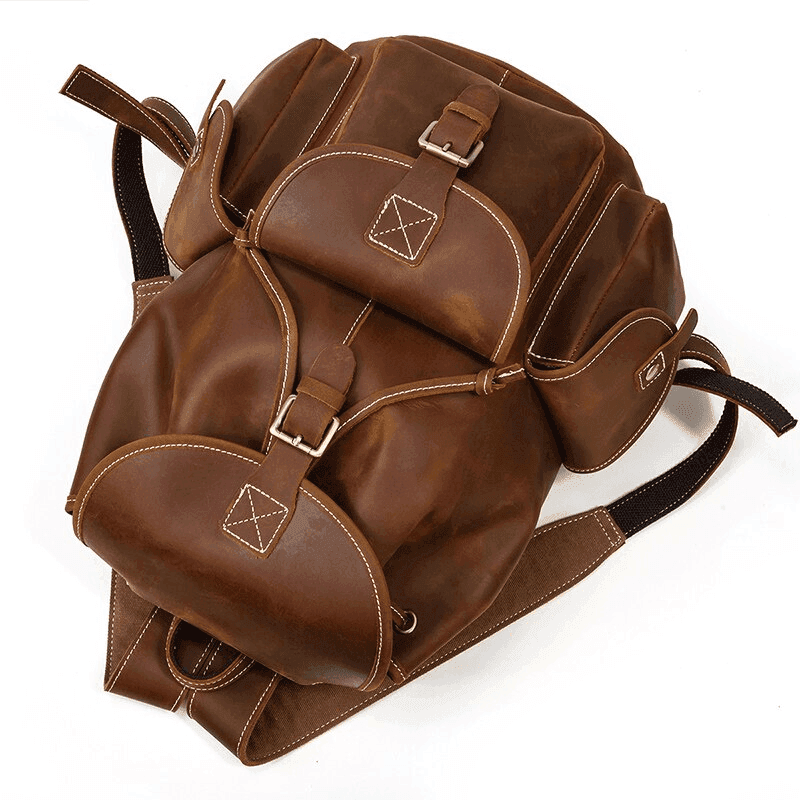 Stylish leather travel backpack in brown with adjustable straps and buckles for travelers