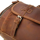 Brown leather weekend bag with shoulder strap showcasing durable stitching and a secure zipper closure