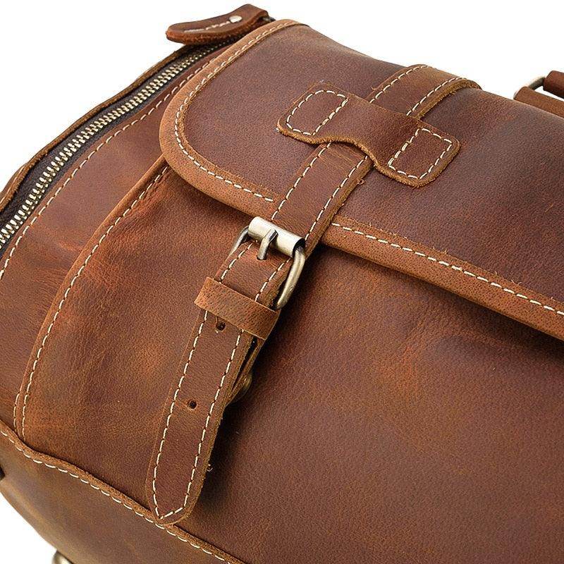 Brown leather weekend bag with shoulder strap showcasing durable stitching and a secure zipper closure
