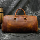 Stylish leather weekend bag with shoulder strap, perfect for travel and outdoor adventures