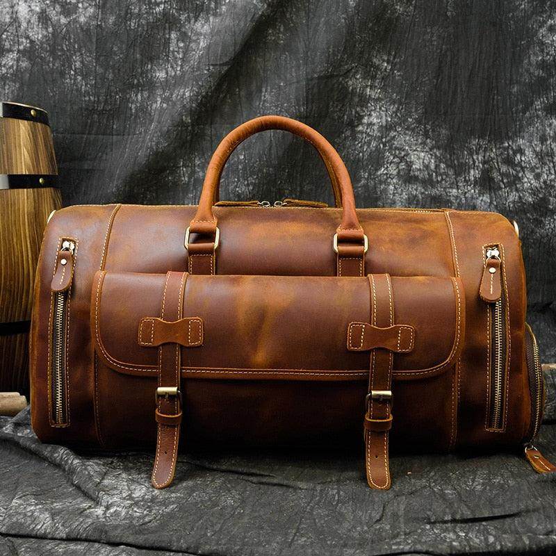 Leather weekend bag with shoulder strap featuring multiple pockets and sturdy handles for travel convenience