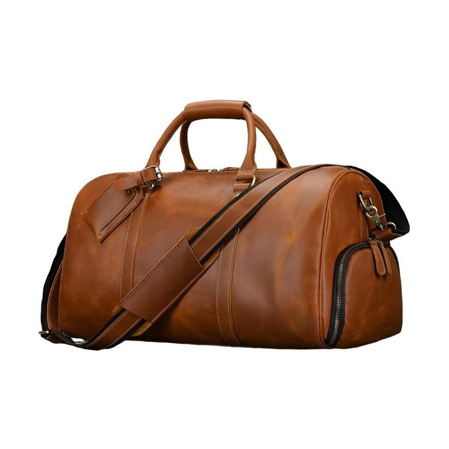 Brown leather weekend bag with shoulder strap, featuring a spacious interior and stylish design