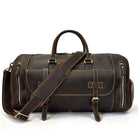 Brown leather weekend bag with shoulder strap featuring multiple pockets and durable handles