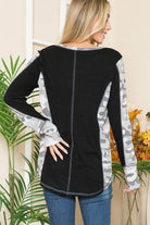 Back view of women's shirt featuring leopard print thumbhole knit design in black and gray