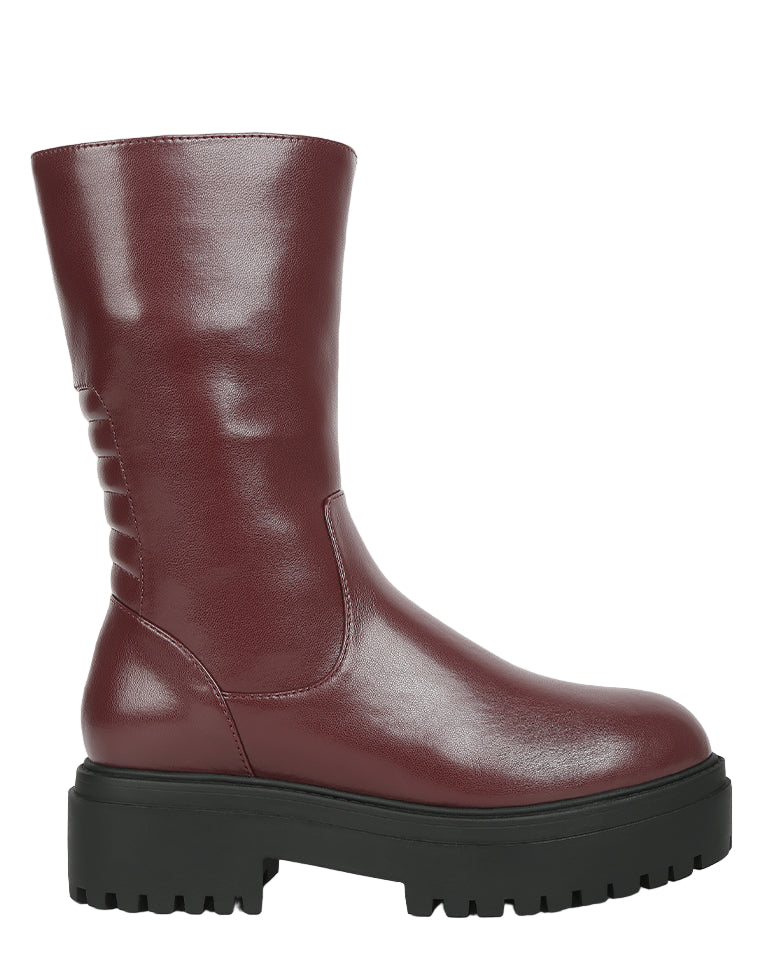 Maroon boot with a thick black sole on a white background