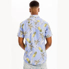 Men's light blue vacation shirt with a tropical pineapple and palm leaf pattern