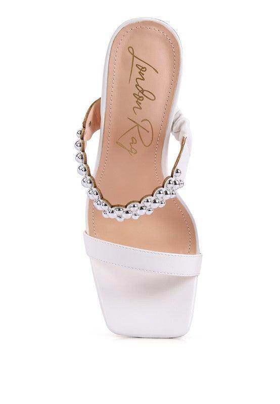 White stylish ball heel shoes with silver embellishments for a chic look