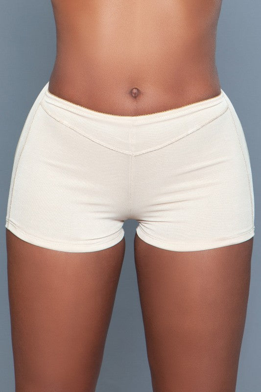 BE WICKED seamless butt enhancer shorts in cream beige on model with V waist and smoothing fit