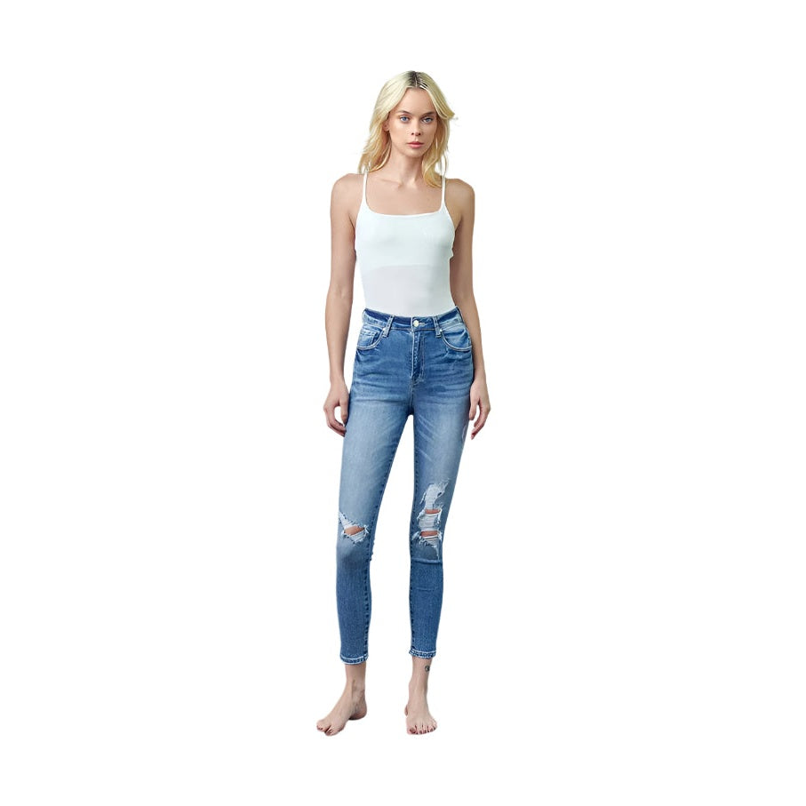 Insane Gene trendy skinny jeans for travel in distressed blue denim worn by model with white tank top