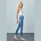 Insane Gene women's trendy skinny jeans for travel in light blue denim styled with a white tank top