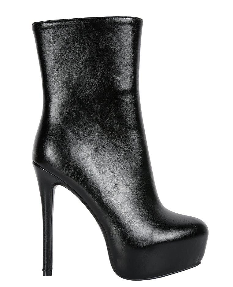 Black high-heeled platform boot on a white background