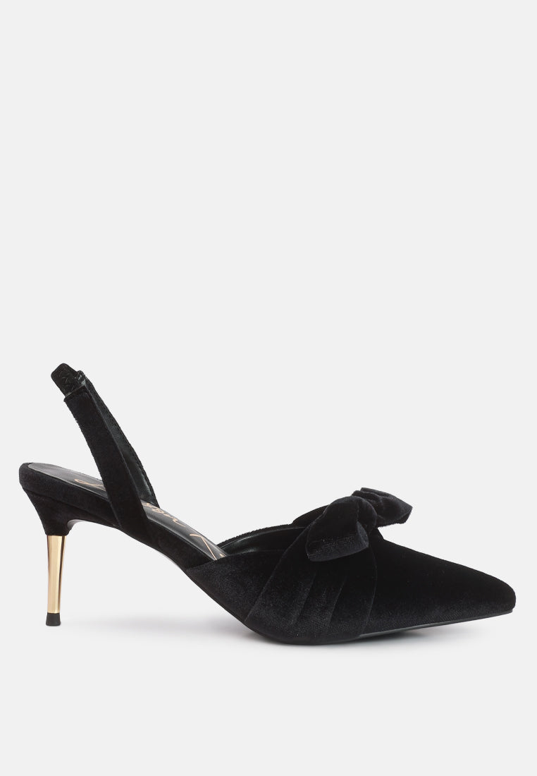 Black velvet slingback shoe with a bow on a white background