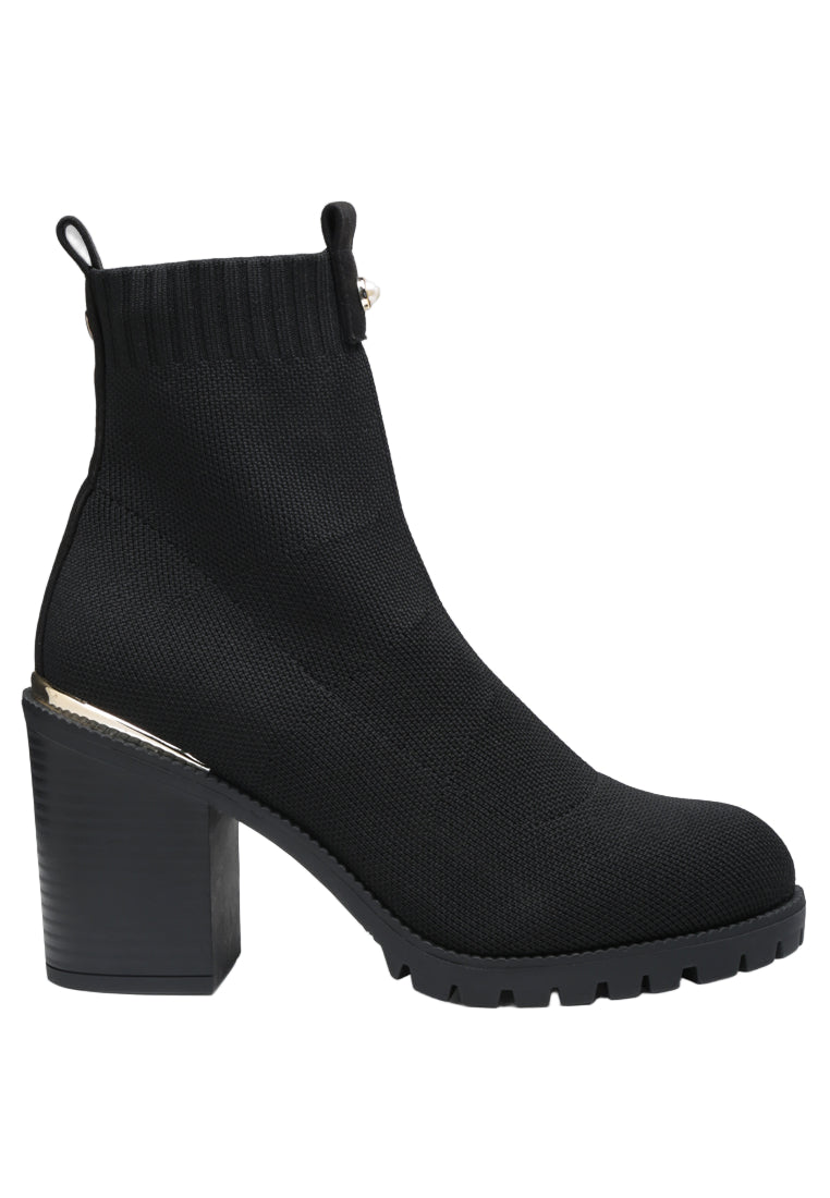 Black sock boot with block heel on a white background