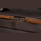 Close-up of a durable mens leather backpack zipper showcasing high-quality materials and craftsmanship