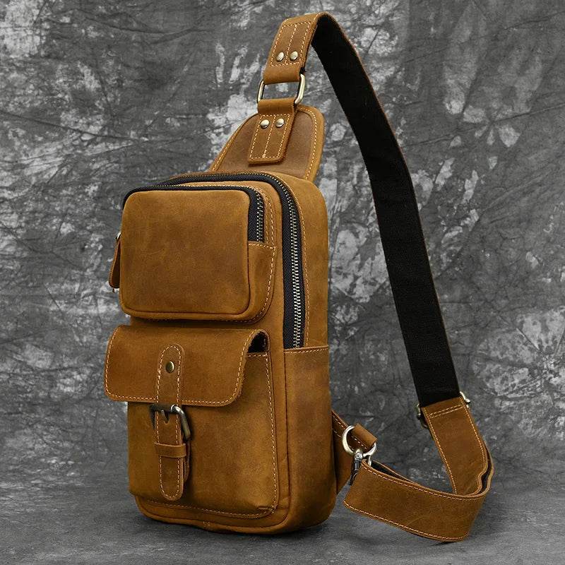 Mens vintage travel chest bag in brown leather with multiple pockets and adjustable strap