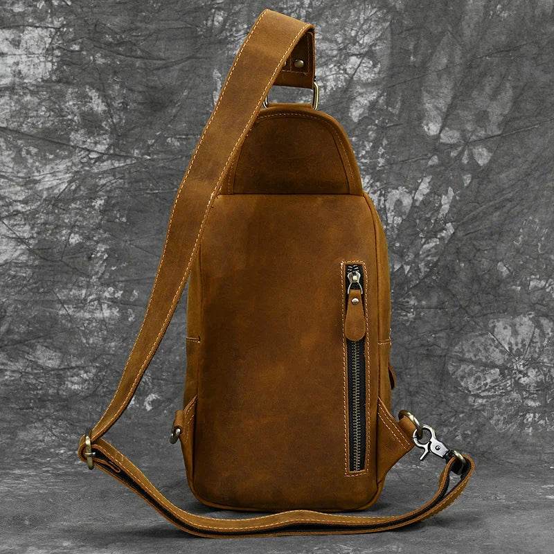 Mens vintage travel chest bag in brown leather with adjustable strap and zip pocket for convenience