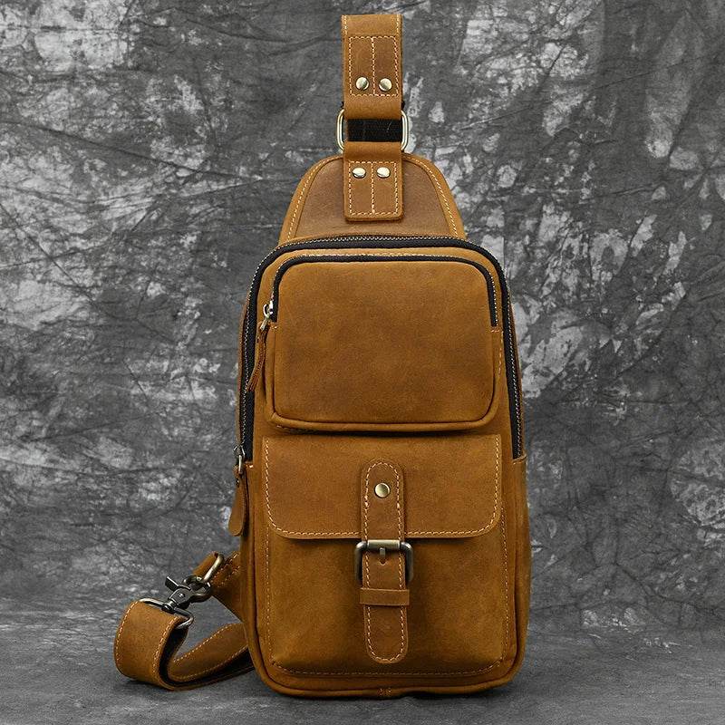 Mens vintage travel chest bag in brown leather with multiple pockets for travel convenience